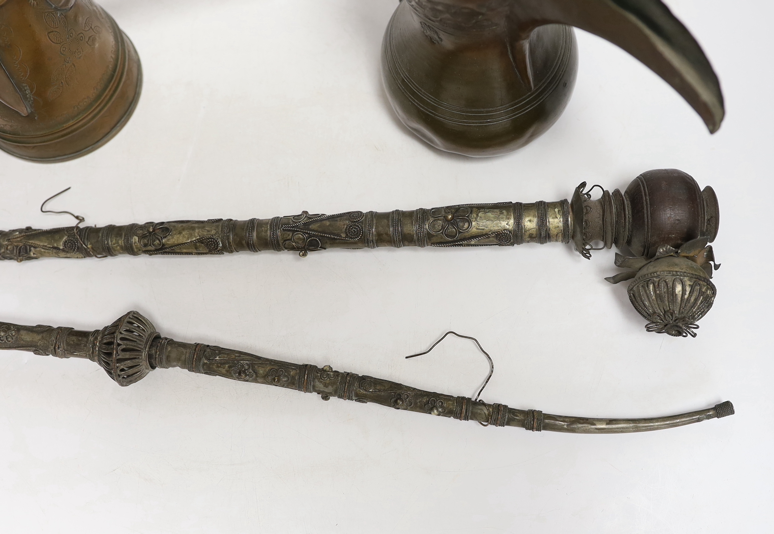 Two Indian opium pipes and two Dallah coffee pots, tallest pot 22cm